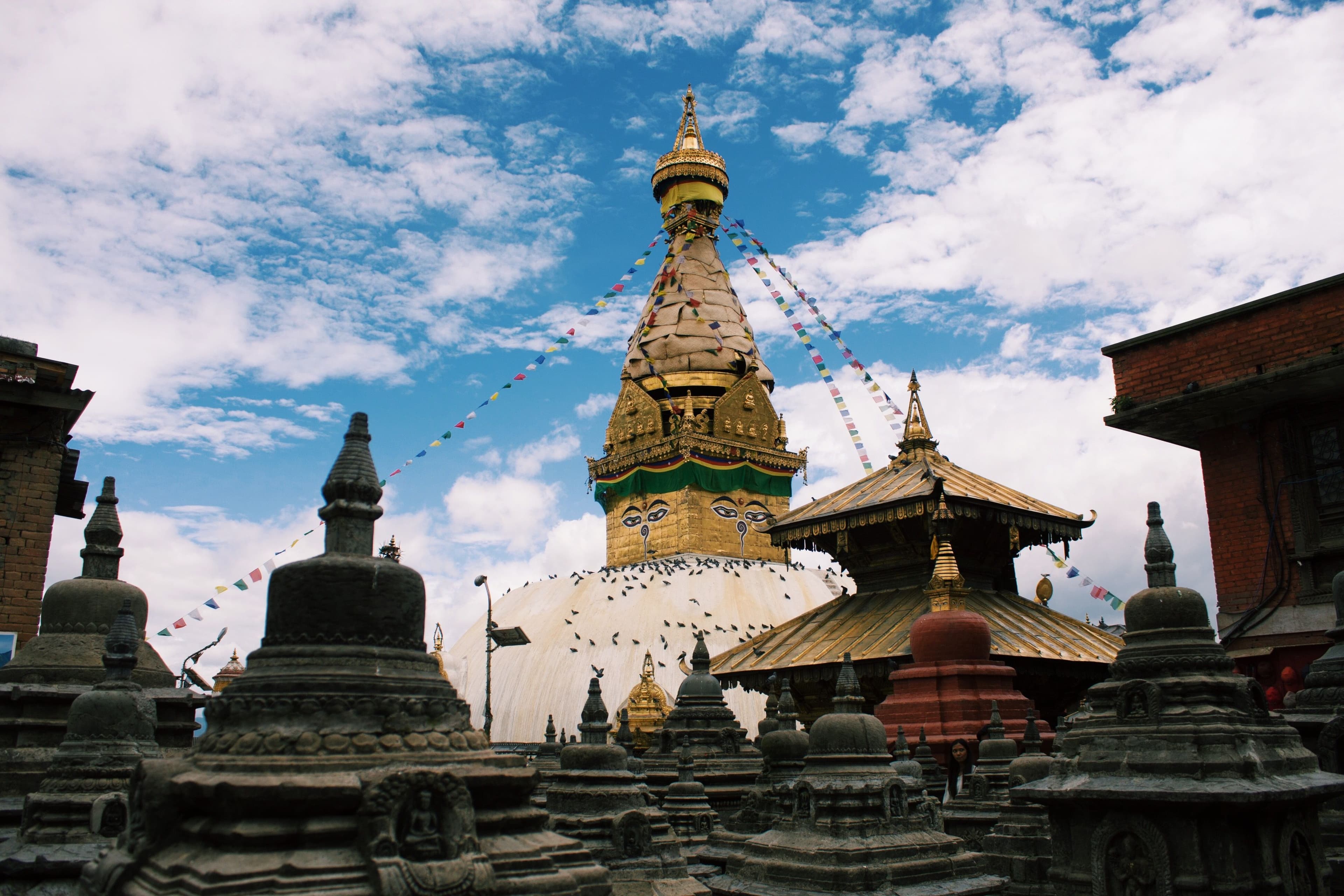 Stupa and prayer flags under a blue sky